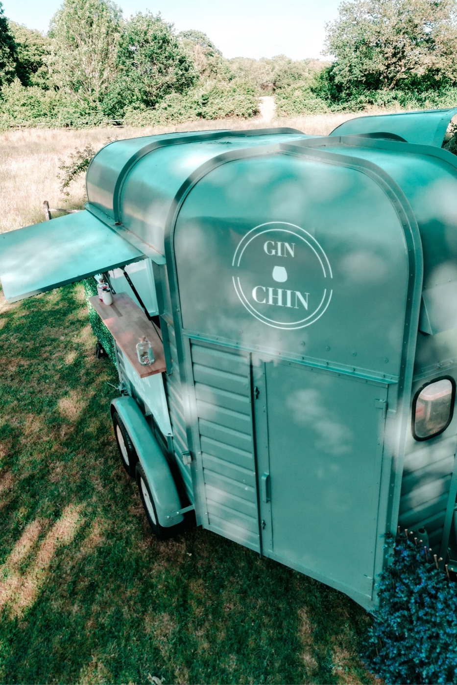 The Gin Chin mobile bar trailer parked in a Devon field