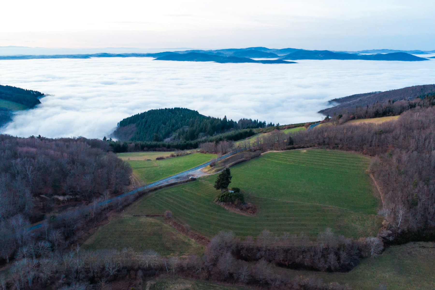 Rolling hills covered in fog with distant islands